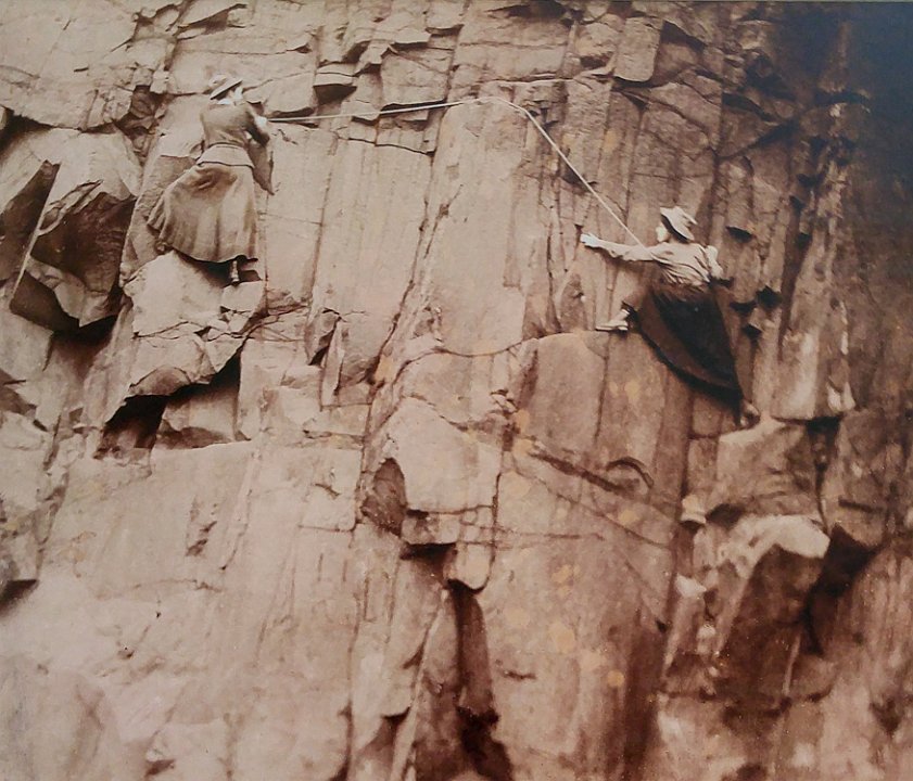 Women scaling the cliffs of Salisbury Crags near Edinburgh, Scotland